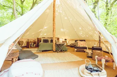 a tent with a living room with a rug at Cuddfan Bach (The Little Hideaway) at Camp Plas in Welshpool