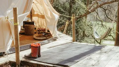 a tent with a mat in front of it at Cuddfan Bach (The Little Hideaway) at Camp Plas in Welshpool