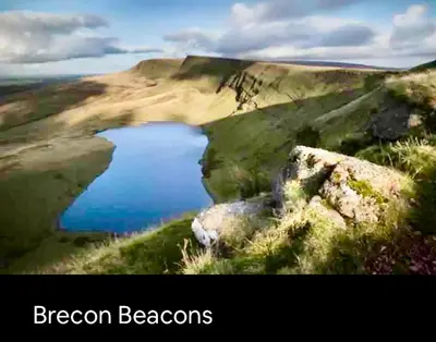 a picture of a lake on a hill with the words dragon beacons at Kookaburra lodge in Brecon