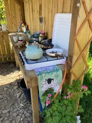 a stove top oven sitting on top of a table at Luxury Stargazing Glamping - Seren Aur with Hot Tub in Llanidloes