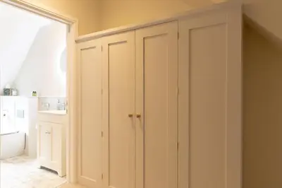 a closet with white cabinets in a room at Plas Robin in Montgomery