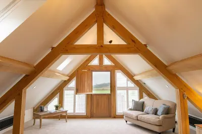 a room with a large window and a couch at Plas Robin in Montgomery