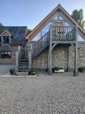 a house with a deck on the side of it at Plas Robin in Montgomery