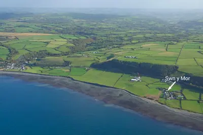 an aerial view of the shore of a body of water at Swn y Mor Aberaeron in Aberaeron