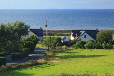 a row of houses next to the ocean at Seabreeze Aberaeron in Aberaeron