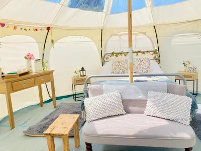 a bedroom with two beds in a tent at Luxury Stargazing Glamping - Seren Hardd with Hot Tub in Llanidloes
