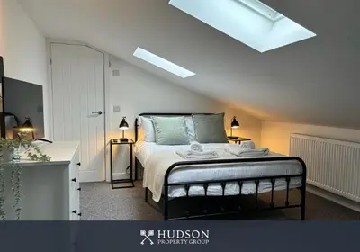 a bedroom with a bed and a skylight at Shrewsbury Townhouse with 3 En-suites in Shrewsbury