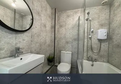 a bathroom with a toilet and a sink and a shower at Shrewsbury Townhouse with 3 En-suites in Shrewsbury