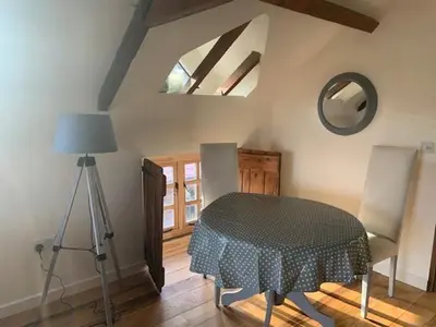 a room with a table and two chairs and a lamp at Beautiful converted Coach house for two in Hoptonheath