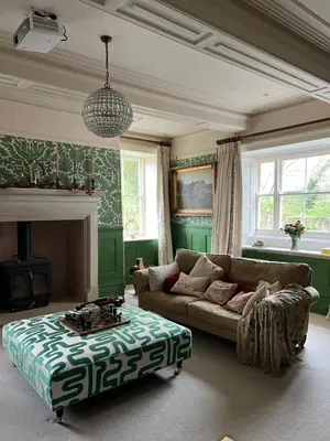 a living room with a couch and a coffee table at The Pink House in Brecon
