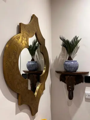 a mirror on a wall with two vases at The Old Rectory Tack Rooms in Shrewsbury