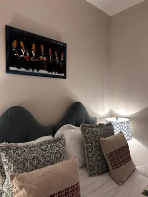 a bedroom with a bed with pillows and a picture on the wall at The Old Rectory Tack Rooms in Shrewsbury