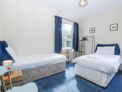a room with two beds and a window at Tawelfan in Llwyngwril