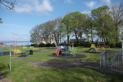 a park with a bunch of different colored playground equipment at Tawelfan in Llwyngwril