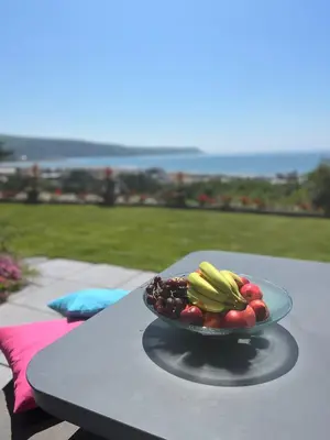 a plate of fruits and vegetables on a table at Y Garth, Sleeps 12 in Barmouth
