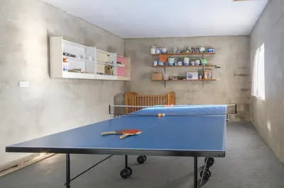 a ping pong table in a room with at Brynonnen Llangrannog in Llanllwchaiarn