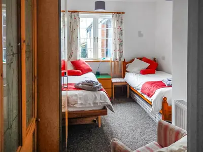 a room with two beds and a window at The Annex At Is Y Coed in Welshpool