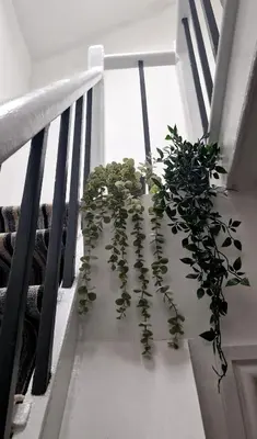a plant sitting on the side of a staircase at The Penthouse NY Loft Apartment in Barmouth