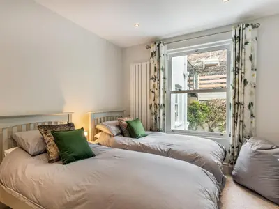 two beds in a room with a window at 4 Bed in Aberdovey 94232 in Aberdyfi
