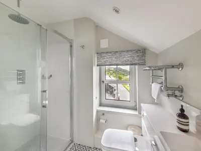 a white bathroom with a shower and a sink at 4 Bed in Aberdovey 94232 in Aberdyfi
