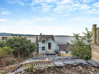 an old house on the shore of a body of water at 4 Bed in Aberdovey 94232 in Aberdyfi