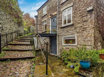 a stone house with stairs leading up to a building at 2 Bed in Brecon oc-92729 in Brecon