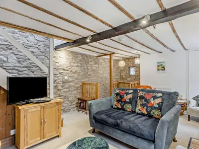 a living room with a couch and a flat screen tv at 2 Bed in Brecon oc-92729 in Brecon