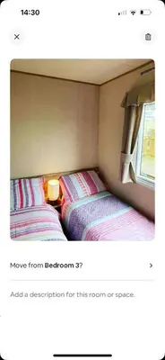 two beds in the corner of a room at AJ’s Caravan Hire in Aberystwyth