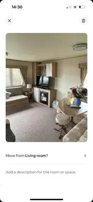 a living room with a couch and a table at AJ’s Caravan Hire in Aberystwyth