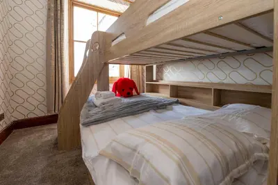 a bedroom with a bunk bed with a red stuffed animal at The Belmont Barmouth in Barmouth