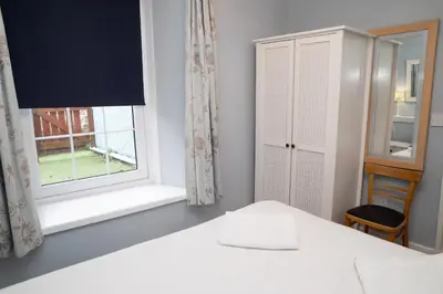 a bedroom with a bed and a window at No. 1 Cliffside New Quay in New Quay