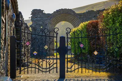 an entrance to a stone gate with an archway at Ty Cellin Tregaron in Ystrad-Meurig