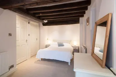 a bedroom with a white bed and a mirror at Grade 2 listed , In the heart of Historic Ludlow. in Ludlow