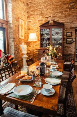 a wooden table with plates of food on it at The Granary Wales in Kington