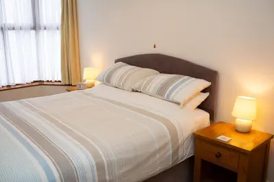 a bedroom with a bed with two lamps on a table at Townhouse Aberystwyth in Aberystwyth