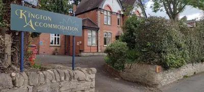 a street sign in front of a brick building at Kington Accommodation in Kington