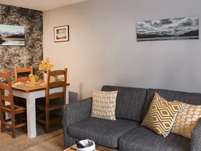 a living room with a couch and a table at Llety Cariad in Bala