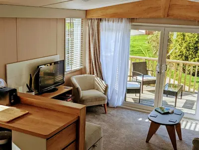 a living room with a television and a balcony at Sarn Y Glyn in Mid Wales Cambrian Mountains near Llanidloes Powys in Caersws