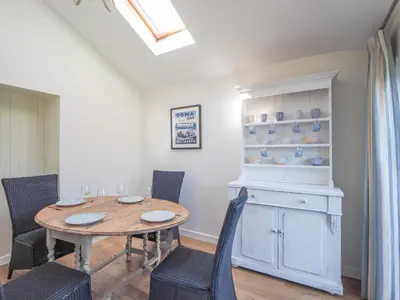 a dining room with a table and chairs at Glenydd New Quay in New Quay