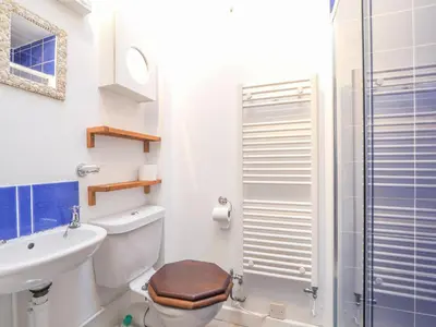 a bathroom with a toilet and a sink and a shower at Glenydd New Quay in New Quay