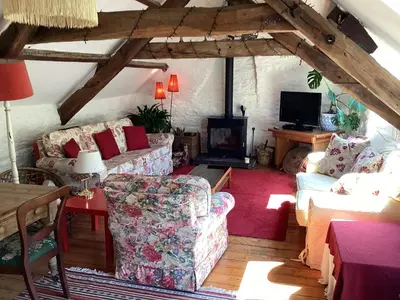 a living room with two couches and a tv at The Old Mill Devils Bridge in Llanilar