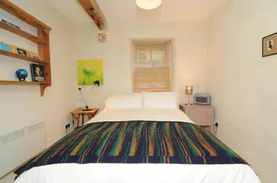 a bedroom with a large bed in a room at The Old Mill Devils Bridge in Llanilar