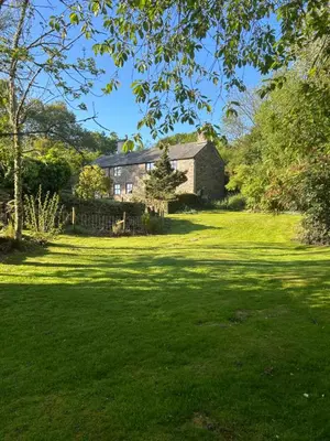 a house on a green lawn with a large yard at Llanerch in Bala