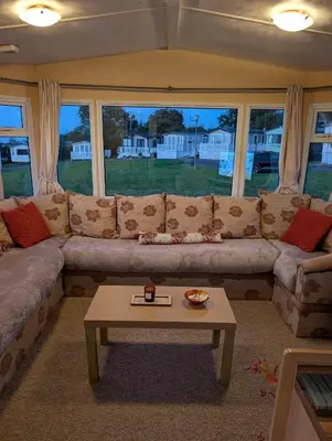 a living room with a couch and a coffee table at 64 Wide Horizon in Aberaeron