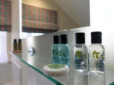 a group of three bottles of soap on a counter at By the River in Glasbury