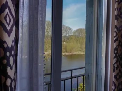a view of a river from a window at By the River in Glasbury