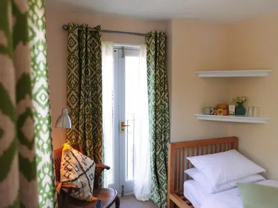 a bedroom with a bed and a window at By the River in Glasbury
