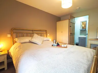a bedroom with a large white bed with two pillows at Bryndalis Aberaeron in Ciliau-Aeron