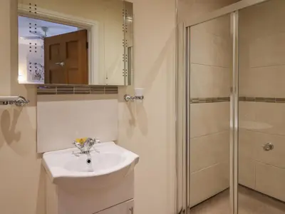 a bathroom with a sink and a shower at Caban Dulas in Rhayader