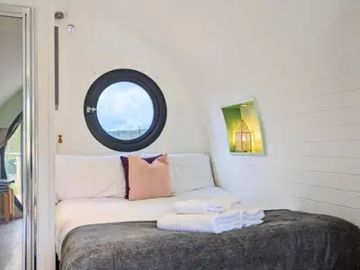a bedroom with a bed with two towels on it at The Heron's Tree in Llandovery